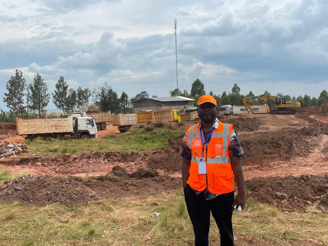 Commercial building construction with cranes and workers in Africa